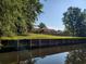 Lovely single story brick home with spacious lawn and large covered front porch located on the water at 5864 Crestwood Dr., Myrtle Beach, SC 29578