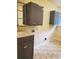 The laundry room features gray cabinets, a sink, and ample space, blending functionality and style at 5864 Crestwood Dr., Myrtle Beach, SC 29578