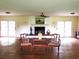 Bright living room featuring a brick fireplace, ceiling fan, and glass doors to the backyard at 5864 Crestwood Dr., Myrtle Beach, SC 29578