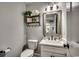 Small bathroom with a toilet, sink, and floating shelves at 1055 Academy Dr., Conway, SC 29526