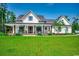 White farmhouse exterior with large front porch and lush green lawn at 1055 Academy Dr., Conway, SC 29526