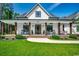 White farmhouse with a welcoming front porch, landscaping and walkway at 1055 Academy Dr., Conway, SC 29526