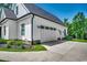 White farmhouse with a three car garage and manicured landscaping at 1055 Academy Dr., Conway, SC 29526