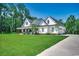 Beautiful white farmhouse with a large covered porch and expansive lawn at 1055 Academy Dr., Conway, SC 29526