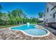 Inviting kidney-shaped pool with a slide and brick patio; located beside the house at 1055 Academy Dr., Conway, SC 29526