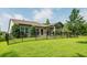 Landscaped backyard, featuring a covered patio and a black metal fence at 1926 Bluff Dr., Myrtle Beach, SC 29577