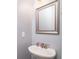 Small bathroom with pedestal sink and framed mirror at 1926 Bluff Dr., Myrtle Beach, SC 29577