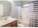 Main bathroom with tub shower and striped curtain at 1926 Bluff Dr., Myrtle Beach, SC 29577