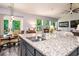 Kitchen island with granite countertop and double sink overlooking the Gathering room at 1926 Bluff Dr., Myrtle Beach, SC 29577