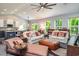 Open concept living room with vaulted ceiling, comfortable seating and large windows at 1926 Bluff Dr., Myrtle Beach, SC 29577