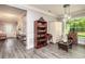 Living room with hardwood floors, built-in shelving, and large windows at 1926 Bluff Dr., Myrtle Beach, SC 29577