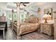 Main bedroom with large four poster bed, plenty of natural light, and hardwood floors at 1926 Bluff Dr., Myrtle Beach, SC 29577