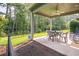 Covered patio with a ceiling fan and outdoor seating, overlooks fenced backyard at 1926 Bluff Dr., Myrtle Beach, SC 29577