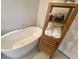 Relaxing bathroom with a freestanding tub and wooden shelving unit at 2020 Santa Maria St., Myrtle Beach, SC 29579