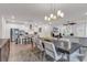 Dining room with large table, chandelier, and open concept to living room at 2020 Santa Maria St., Myrtle Beach, SC 29579