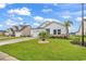 White house with landscaping, driveway, and palm trees at 2020 Santa Maria St., Myrtle Beach, SC 29579