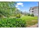 Serene backyard view overlooking lush greenery, a pond, and the building's exterior at 4709 Wild Iris Dr. # 104, Myrtle Beach, SC 29577