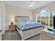 Bedroom featuring a queen bed with coastal themed linens, a nightstand, and a window with blinds at 4709 Wild Iris Dr. # 104, Myrtle Beach, SC 29577