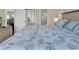 Main bedroom featuring a queen bed with coastal-themed linens and access to bathroom and living areas at 4709 Wild Iris Dr. # 104, Myrtle Beach, SC 29577