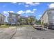 Condo complex featuring a stone and stucco exterior with palm trees and well-maintained landscaping at 4709 Wild Iris Dr. # 104, Myrtle Beach, SC 29577