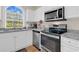 Kitchen with white cabinetry, granite countertops, and stainless steel appliances at 4709 Wild Iris Dr. # 104, Myrtle Beach, SC 29577