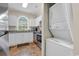 Kitchen with white cabinets, stainless steel appliances, and stacked washer/dryer at 4709 Wild Iris Dr. # 104, Myrtle Beach, SC 29577