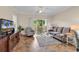 Living room with tile floors, large windows and doors to an outdoor balcony at 4709 Wild Iris Dr. # 104, Myrtle Beach, SC 29577