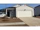 One story home with gray siding, white trim, and a two-car garage at 707 El Pepino Loop, Longs, SC 29568