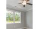 This bedroom showcases a ceiling fan, neutral walls, white trim and a large window at 104 Infinity Ln., Loris, SC 29569