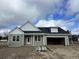 Newly built home with green siding, white accents and a two-car garage at 107 Infinity Ln., Loris, SC 29569