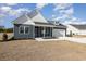 Two-story home with gray siding, white accents, and a two-car garage at 107 Infinity Ln., Loris, SC 29569