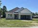 New home features neutral siding, white trim, and an attached two-car garage on a sunny day at 108 Infinity Ln., Loris, SC 29569