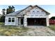 Unfinished single-Gathering house with white wrap exterior and two-car garage with ample space at 108 Infinity Ln., Loris, SC 29569