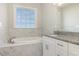 Well-lit bathroom with a soaking tub and granite countertops offers relaxation and style at 112 Infinity Ln., Loris, SC 29569