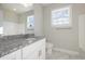 Bright bathroom featuring a granite countertop, modern fixtures, and marble-patterned tile floors at 112 Infinity Ln., Loris, SC 29569