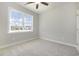 Comfortable bedroom with neutral colors, ceiling fan, and a large window at 112 Infinity Ln., Loris, SC 29569