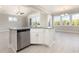 Modern kitchen island featuring a sink, dishwasher, and white cabinets, creating an open, airy space at 112 Infinity Ln., Loris, SC 29569