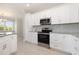 White kitchen cabinets paired with stainless steel appliances and granite countertops providing an open feel at 112 Infinity Ln., Loris, SC 29569