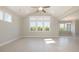 Bright living room featuring vaulted ceilings, a ceiling fan, and large windows with natural light at 112 Infinity Ln., Loris, SC 29569