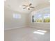 Bright living room featuring vaulted ceilings, a ceiling fan, and large windows with natural light at 112 Infinity Ln., Loris, SC 29569