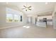 Open concept living space with the kitchen in the background featuring white cabinets and stainless steel appliances at 112 Infinity Ln., Loris, SC 29569
