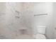 Luxurious shower with marble tile, built-in shelves, and a comfortable corner seat at 112 Infinity Ln., Loris, SC 29569