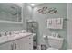 Bright bathroom with a large mirror and a tiled shower-tub combo at 1207 S Ocean Blvd. # 20509, Myrtle Beach, SC 29577