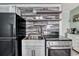 Kitchen area featuring stainless steel appliances, modern backsplash, and floating shelves at 1207 S Ocean Blvd. # 20509, Myrtle Beach, SC 29577