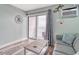 Living room with gray sofa, wood-look laminate flooring, and sliding glass doors to balcony at 1207 S Ocean Blvd. # 20509, Myrtle Beach, SC 29577