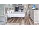 Studio with bed, dining table, dresser, and kitchen area; wood look laminate flooring throughout at 1207 S Ocean Blvd. # 20509, Myrtle Beach, SC 29577
