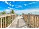 Wooden boardwalk leading to a beautiful beach with clear blue water at 1207 S Ocean Blvd. # 20509, Myrtle Beach, SC 29577