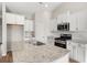Modern kitchen with stainless steel appliances, granite countertops, white cabinets, and a spacious island at 343 Hayloft Circle, Conway, SC 29526