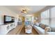Bright living room showcasing hardwood floors and a large flat-screen TV at 35 Delray Dr. # 1-E, Murrells Inlet, SC 29576