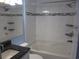 Updated bathroom with granite vanity, tiled shower/tub combo, and shelves at 5601 Ocean Blvd. N # 202 A, Myrtle Beach, SC 29577